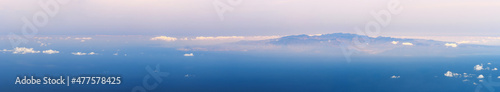 Panorama of the Grand-Canary island in a morning haze, view from top point of the crater Teide volcano on the island of Tenerife, the Canary Islands, Spain. Calm landscape in pastel colors for banner.