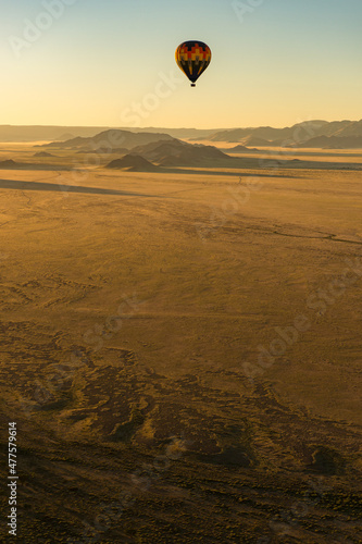 A vertical shot of a hot air balloon flight over the Sossusvlei landscape at sunrise, Namibia, Africa