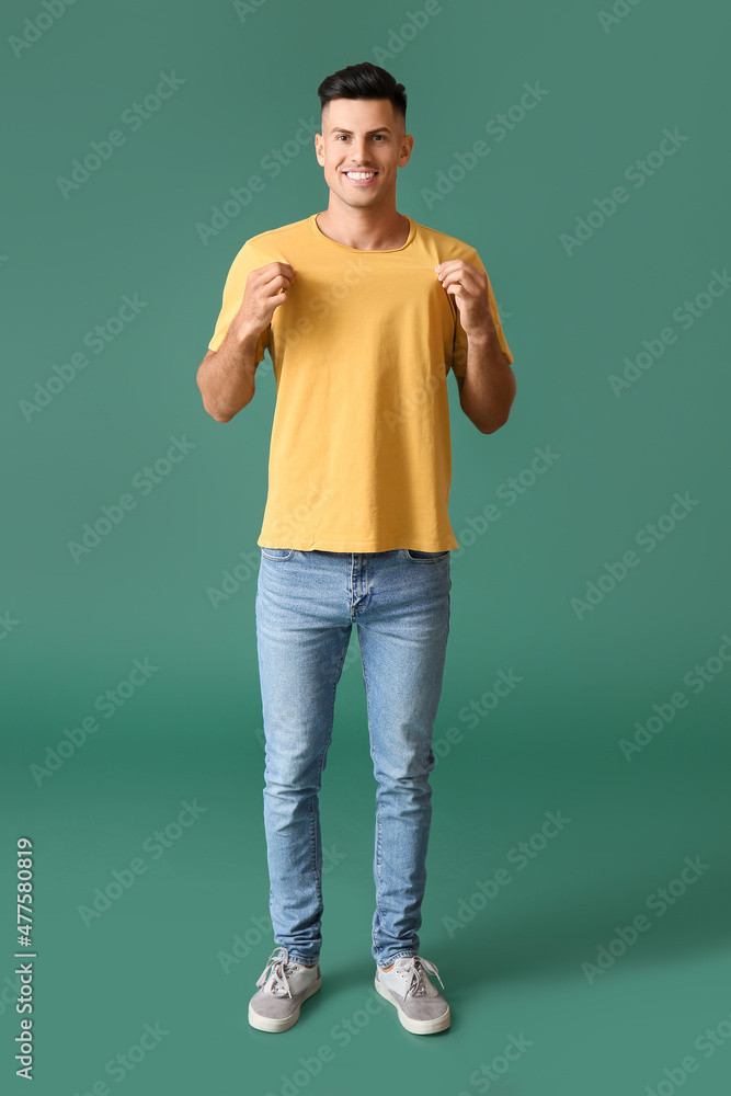 Handsome young man in stylish t-shirt on color background Handsome young man in stylish t-shirt on color background