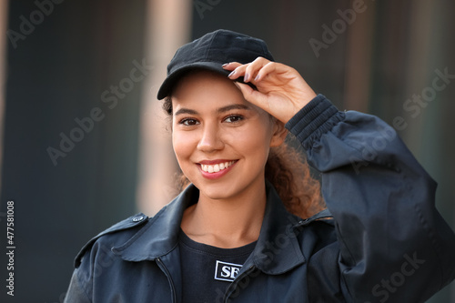 Papier peint Smiling African-American female security guard outdoors, closeup
