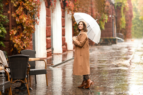 Smiling woman with umbrella...
