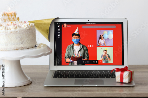 Laptop, gift and cake on ta...