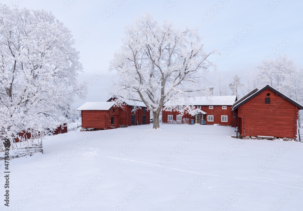 Red house in a wintry landscape Red house in a wintry landscape