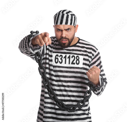 Angry prisoner in special uniform with chained hands on white background photo