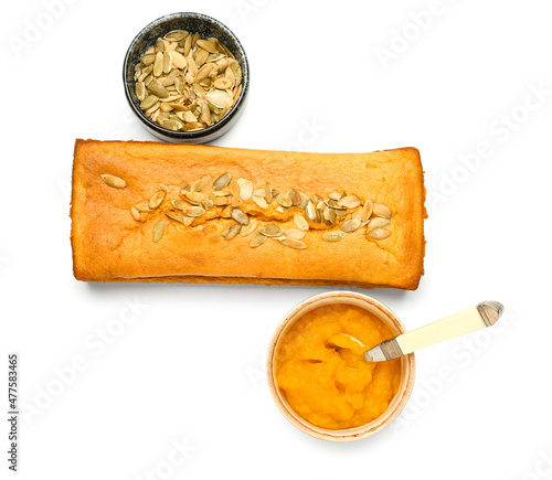 Fresh pumpkin pie and bowl with seeds on white background