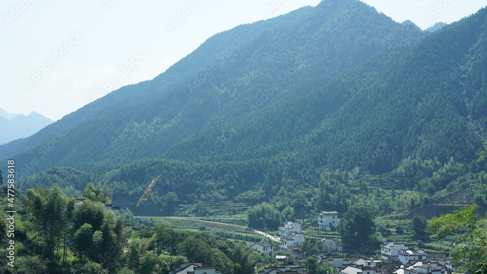 The beautiful mountains landscapes with the green forest and little village as background in the countryside of the China