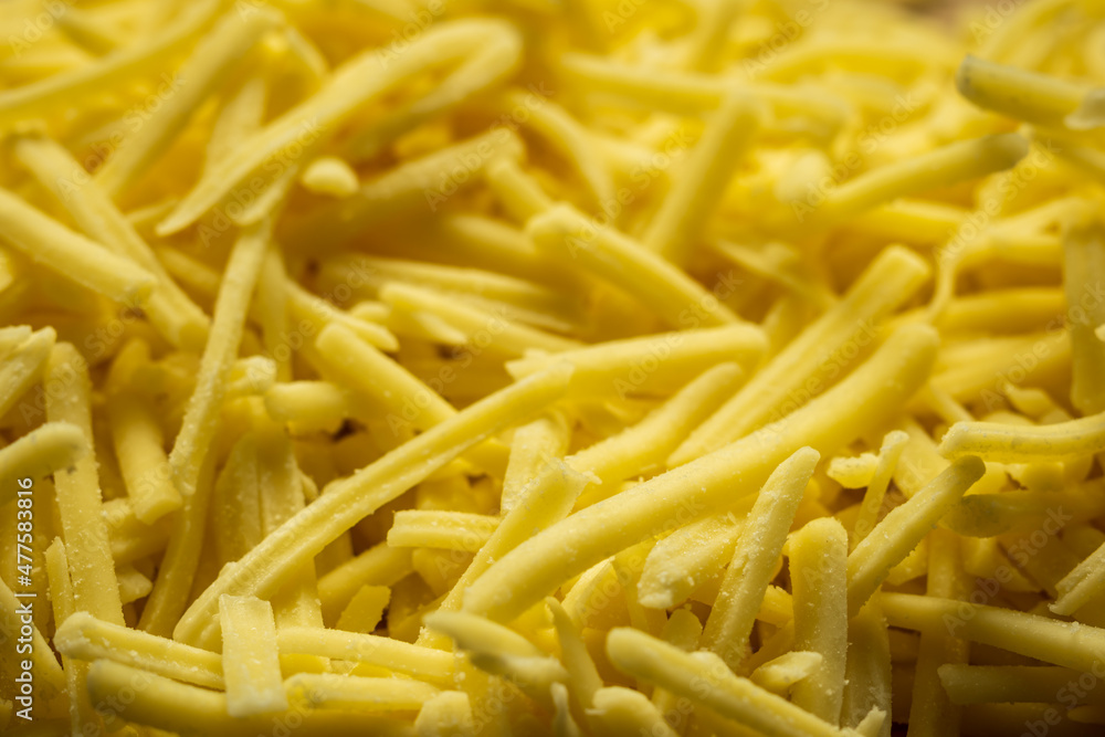 grated cheddar cheese background closeup grated cheddar cheese background closeup