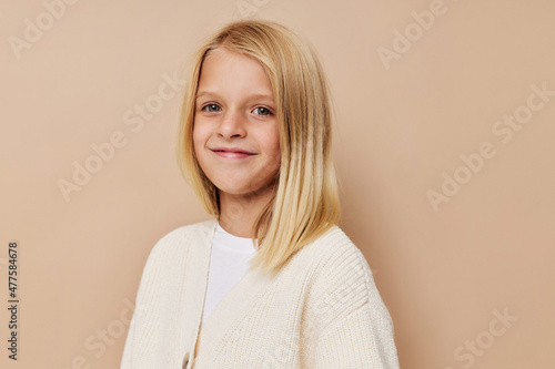 Positive little girl in a white sweater cropped view