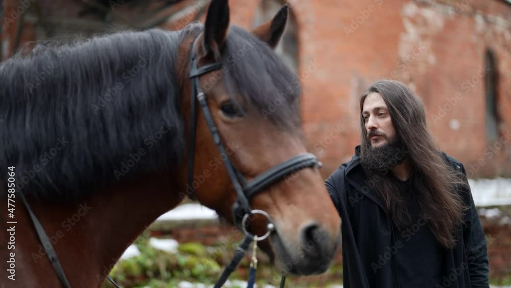 enigmatic man with horse in yard of ancient castle, historical shot enigmatic man with horse in yard of ancient castle, historical shot