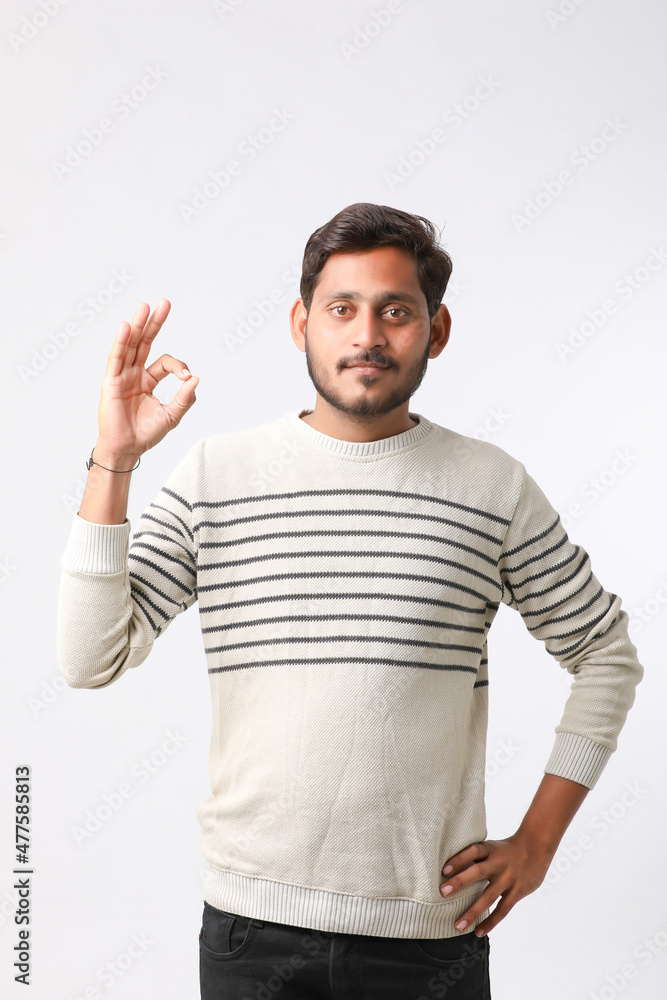 Young indian man giving expression on white background. Young indian man giving expression on white background.