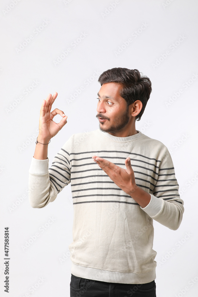 Young indian man giving expression on white background. Young indian man giving expression on white background.