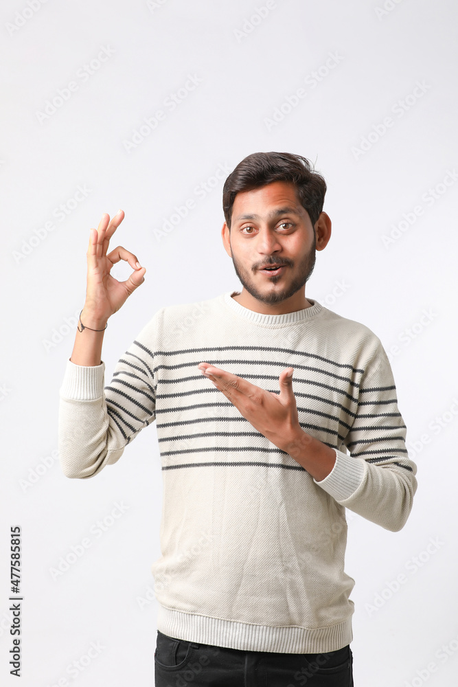 Young indian man giving expression on white background. Young indian man giving expression on white background.