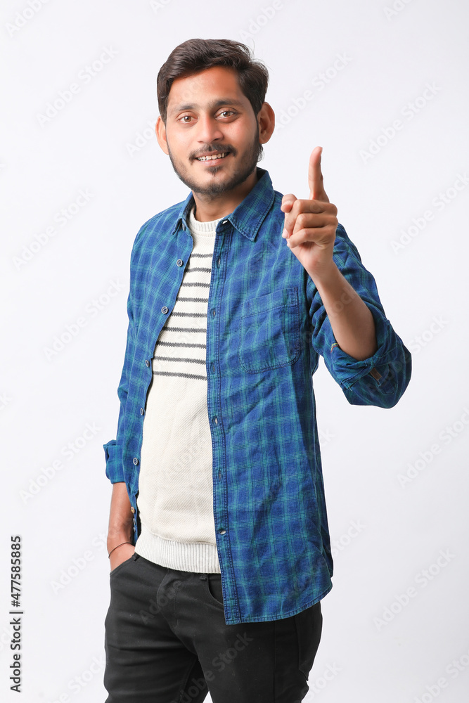 Young indian man giving expression on white background. Young indian man giving expression on white background.