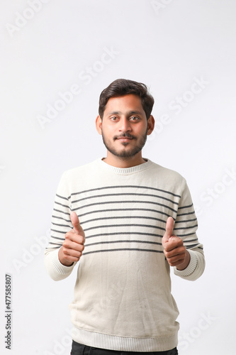 Young indian man giving expression on white background.