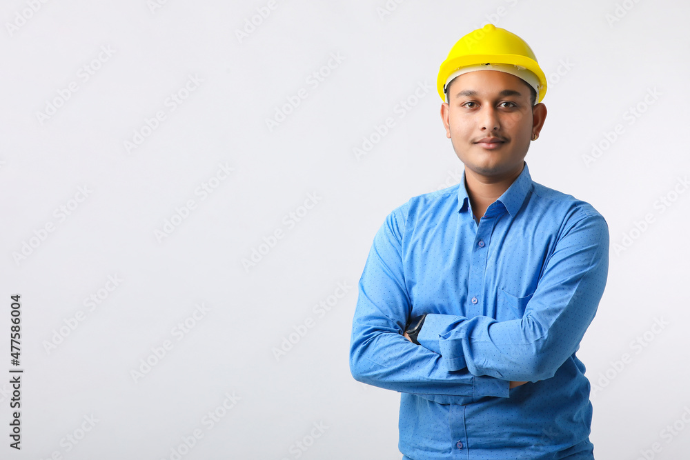 Young Indian engineer wearing yellow color hard hat and giving successful gesture. Young Indian engineer wearing yellow color hard hat and giving successful gesture.