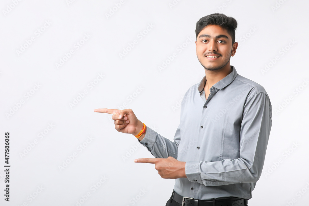 Successful Young indian business man posing over white background. Successful Young indian business man posing over white background.
