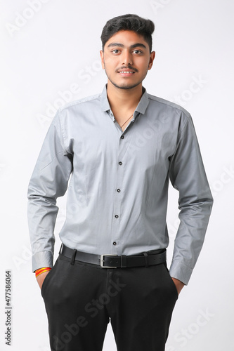 Successful Young indian business man posing over white background.