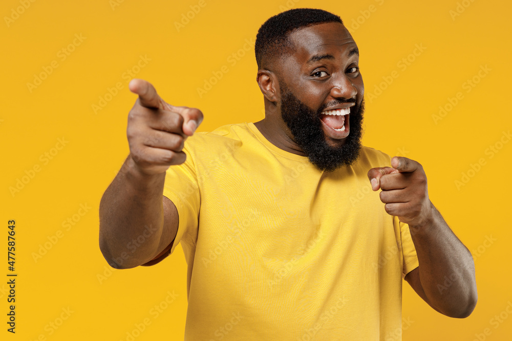 Young smiling happy black man 20s wearing bright casual t-shirt point ...