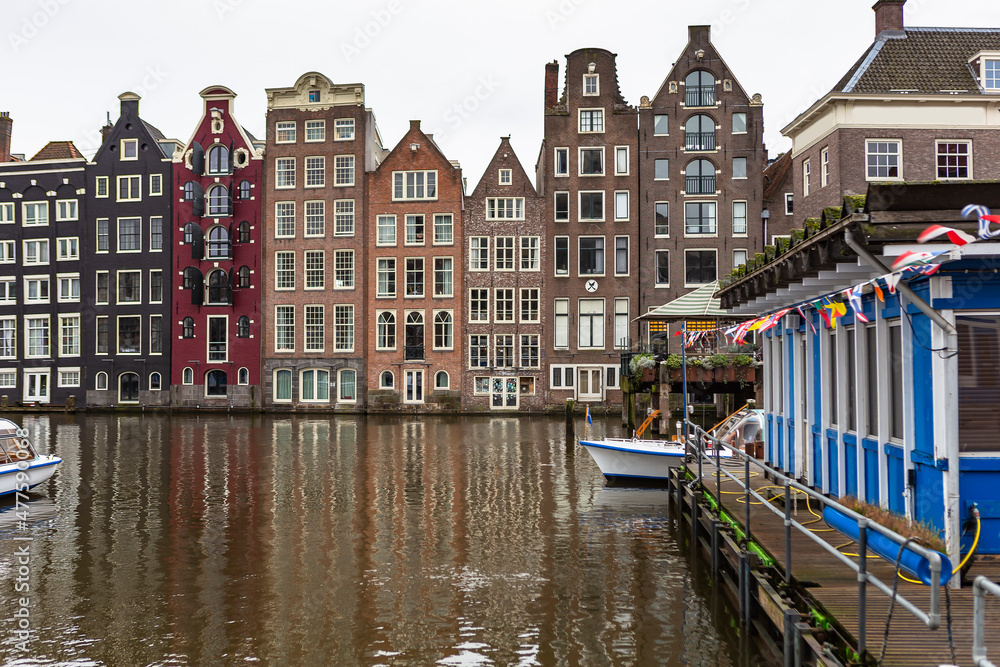 Dutch houses built along the Amstel river in Amsterdam, Netherlands.