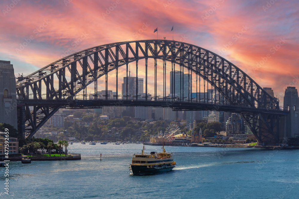 Naklejka premium View of Sydney Harbour NSW Australia. Ferry boats partly cloudy colourful skies blue waters