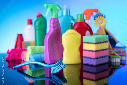 House and office cleaning products. Colorful cleaning kit on blue background.