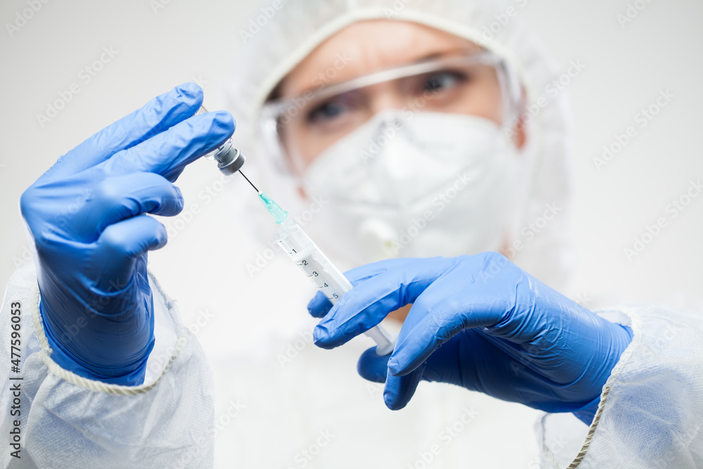 Medical worker preparing COVID-19 vaccine isolated on white background Medical worker preparing COVID-19 vaccine isolated on white background