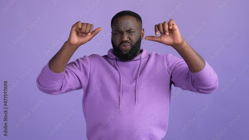 Upset guy make thumb down symbol criticize isolated vivid color background Upset guy make thumb down symbol criticize isolated vivid color background