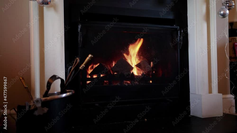 Fireplace in home setting with logs burning. Roaring fire with flames footage in 4k real time motion. Warm cosy interior video Fireplace in home setting with logs burning. Roaring fire with flames footage in 4k real time motion. Warm cosy interior video