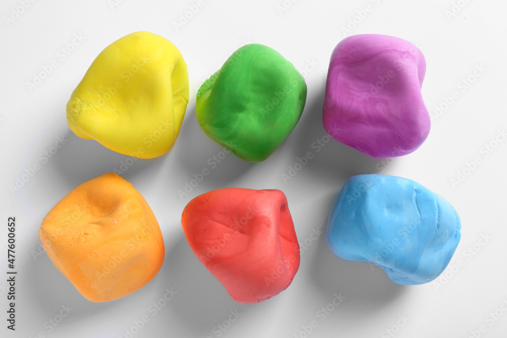 Different color play dough on white background, top view Different color play dough on white background, top view