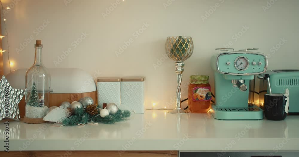 interior of a white-blue kitchen with a decorated Christmas tree and garlands. close-up. interior of a white-blue kitchen with a decorated Christmas tree and garlands. close-up.