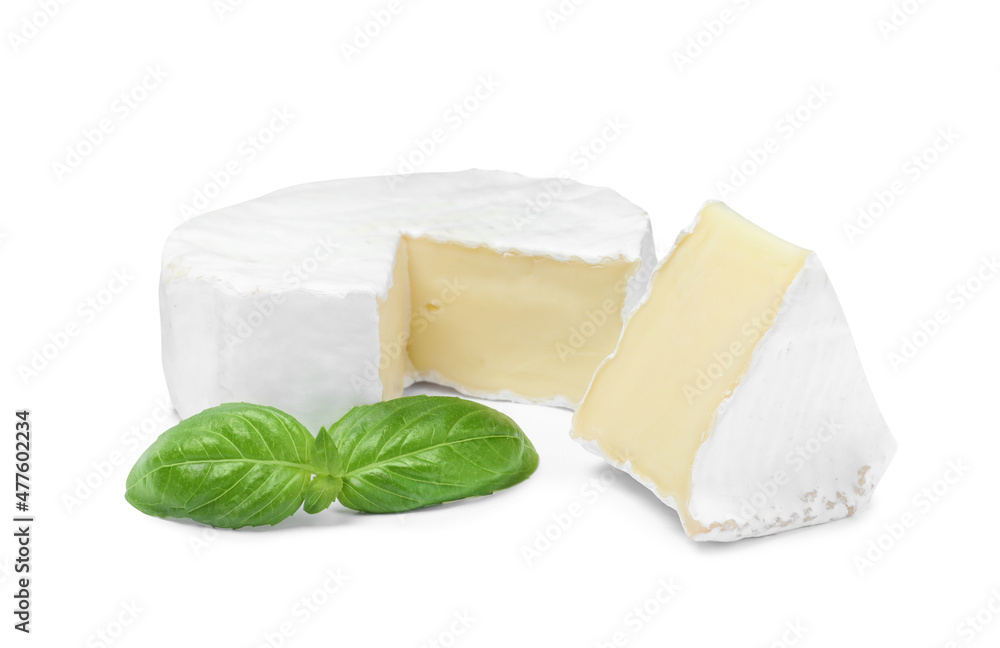 Tasty cut brie cheese with basil on white background - obrazy, fototapety, plakaty 