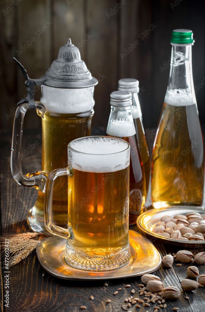 Light beer in a glass on an old background. Light beer in a glass on an old background.