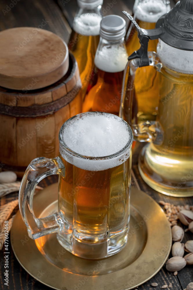 Light beer in a glass, on an old background. Light beer in a glass, on an old background.