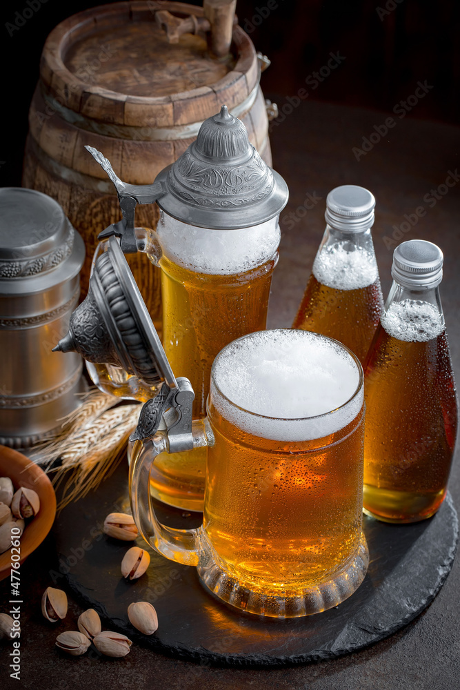 Light beer in a glass, on an old background. Light beer in a glass, on an old background.