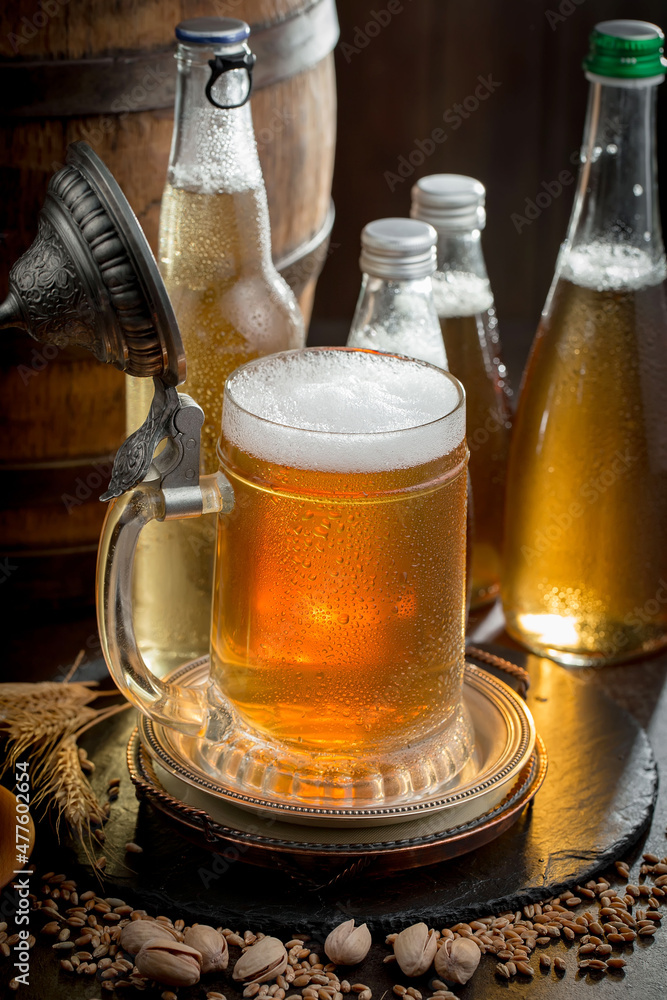 Light beer in a glass on an old background. Light beer in a glass on an old background.