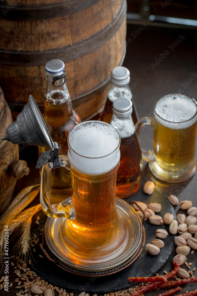 Light beer in a glass on an old background. Light beer in a glass on an old background.