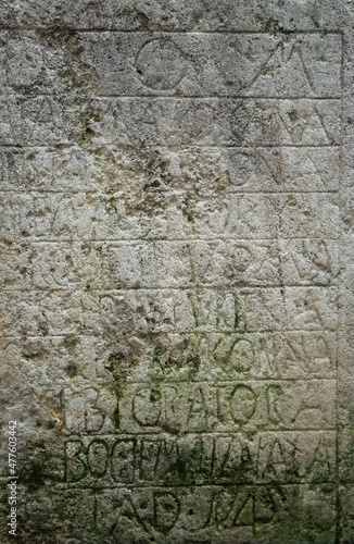 Ancient stone with medieval latin writing. Ancient church