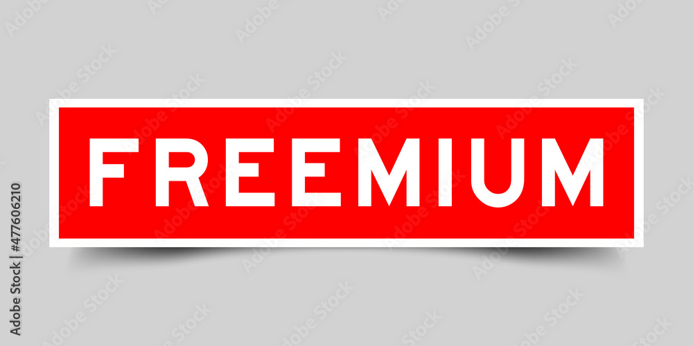 Sticker label with word freemium in red color on gray background