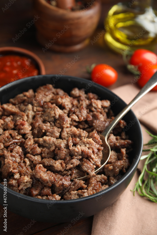 Fried minced meat and different products on wooden table, closeup