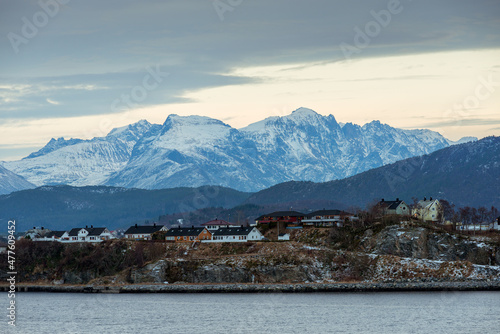 A horizontal shot of the Norwegian landscape taken from a boat on the sea in the early evening, Norway