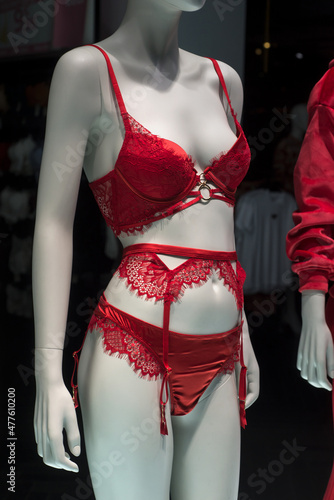 Closeup of red suspended belt ans red lace bra on mannequin in a fashion store showroom