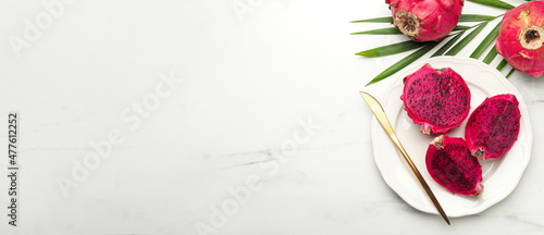 Delicious dragon fruits  pitahaya  on white marble table  flat lay with space for text. Banner design