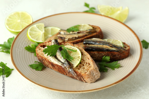 Concept of tasty snack with sandwiches with sprats