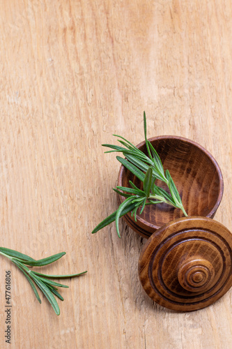 Sprig of rosemary in wooden box.