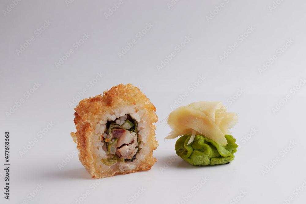 several different rolls on the table, Asian food, side view, light background, sushi, ginger and wasabi several different rolls on the table, Asian food, side view, light background, sushi, ginger and wasabi