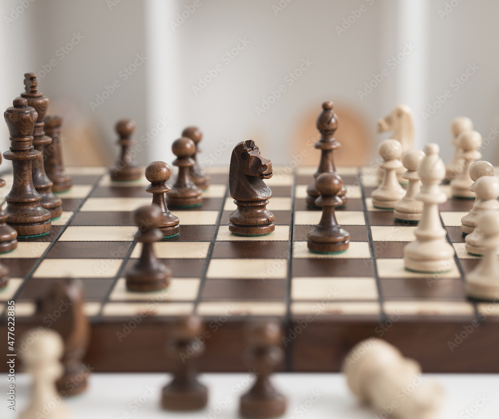 Chess board figures for playing chess are located on a wooden board, in sharpness the main plan is the figure of a chess horse. game of chess
Chess board figures for playing chess are located on a wooden board, in sharpness the main plan is the figure of a chess horse. game of chess