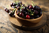 Fresh ripe cherry in a wooden bowl