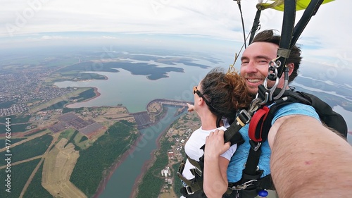 Skydive tandem selfie above Itaípu Dam, between Brazil and Paraguay. photo