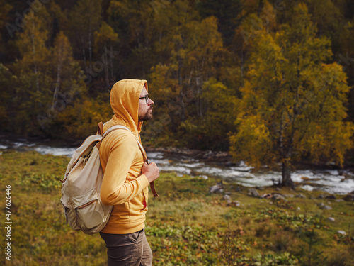 Man hikes mountains with travel backpack. Wandering lifestyle, adventure concept autumn vacation outdoors, alone in wild. Travel to North Caucasus, Arkhyz, Russia © YURII Seleznov