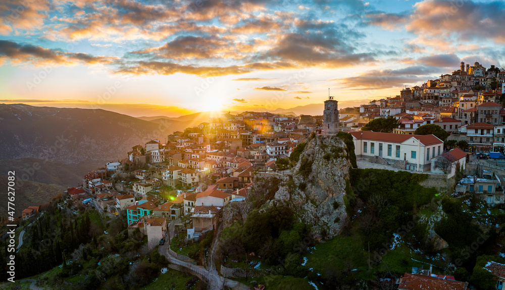 Panoramic aerial view of the mountain village Arachova, Boiotia, Greece, tourist resort for ski and trekking sports during a golden winter sunset